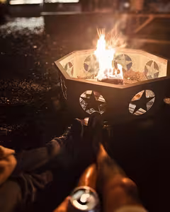 Relaxing by the star-shaped fire pit on a cool evening at Splash RV Resort
