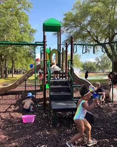 Children playing on the playground on a sunny day at Splash RV Resort