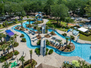 Aerial view of Splash RV Resort showing the winding lazy river, swimming pools, water slides and shaded RV sites