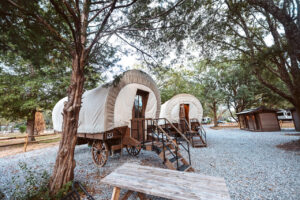 Conestoga covered wagon glamping unit at Splash RV Resort near Navarre Beach