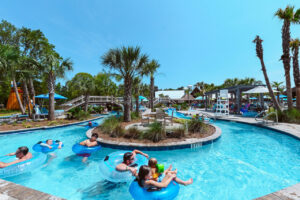 Guests floating the lazy river on blue tubes at Splash RV Resort near Pensacola