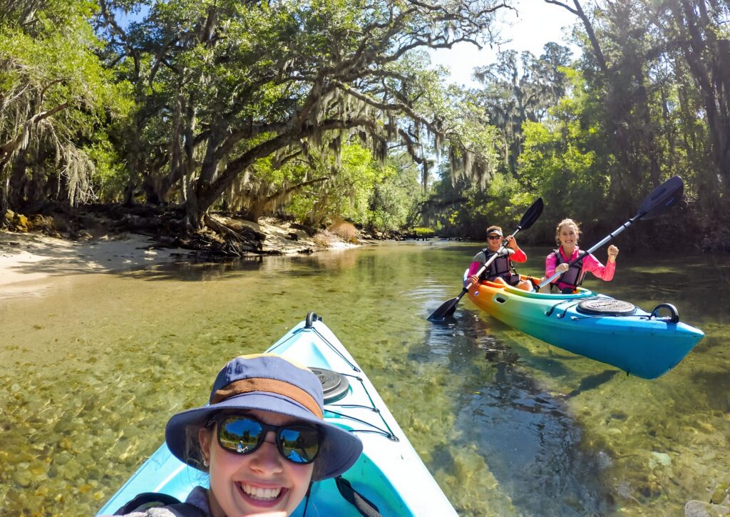 A couple kayaking on a clear spring-fed Florida Panhandle creek near Milton