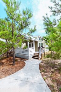 Luxury cabin rental exterior with a covered front porch at Splash RV Resort near Navarre Beach