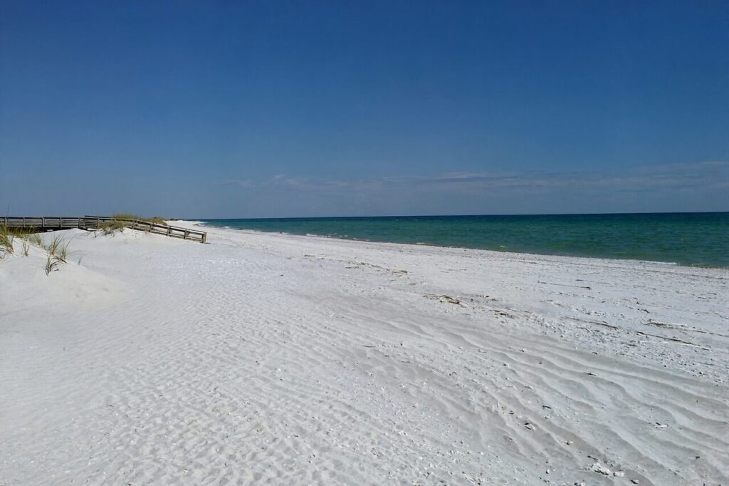Sugar-white sand and emerald-green Gulf water at a Florida Panhandle beach near Navarre Beach