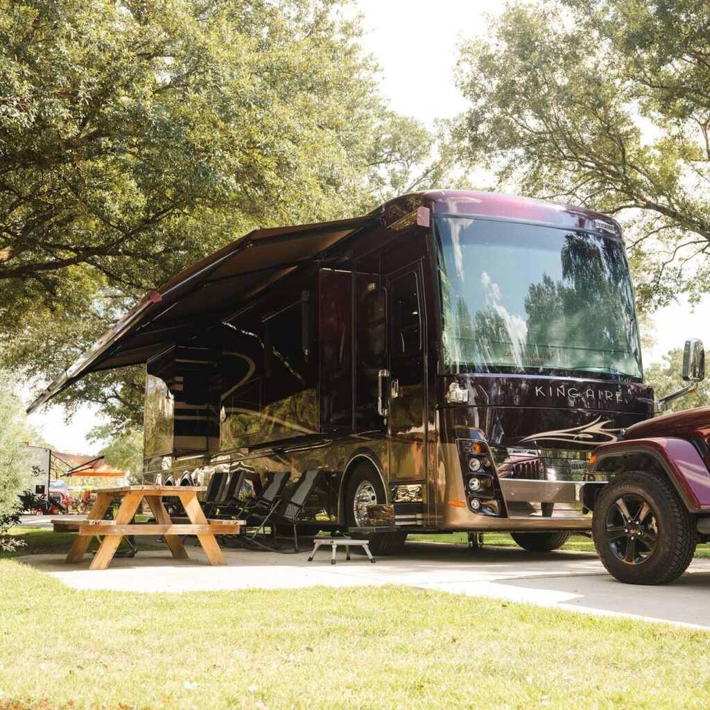 Big rig motorhome on a level concrete full-hookup site at Splash RV Resort