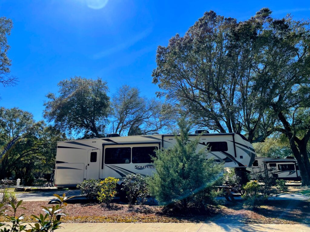 Fifth wheel RV on a shaded full hookup site at Splash RV Resort near Pensacola