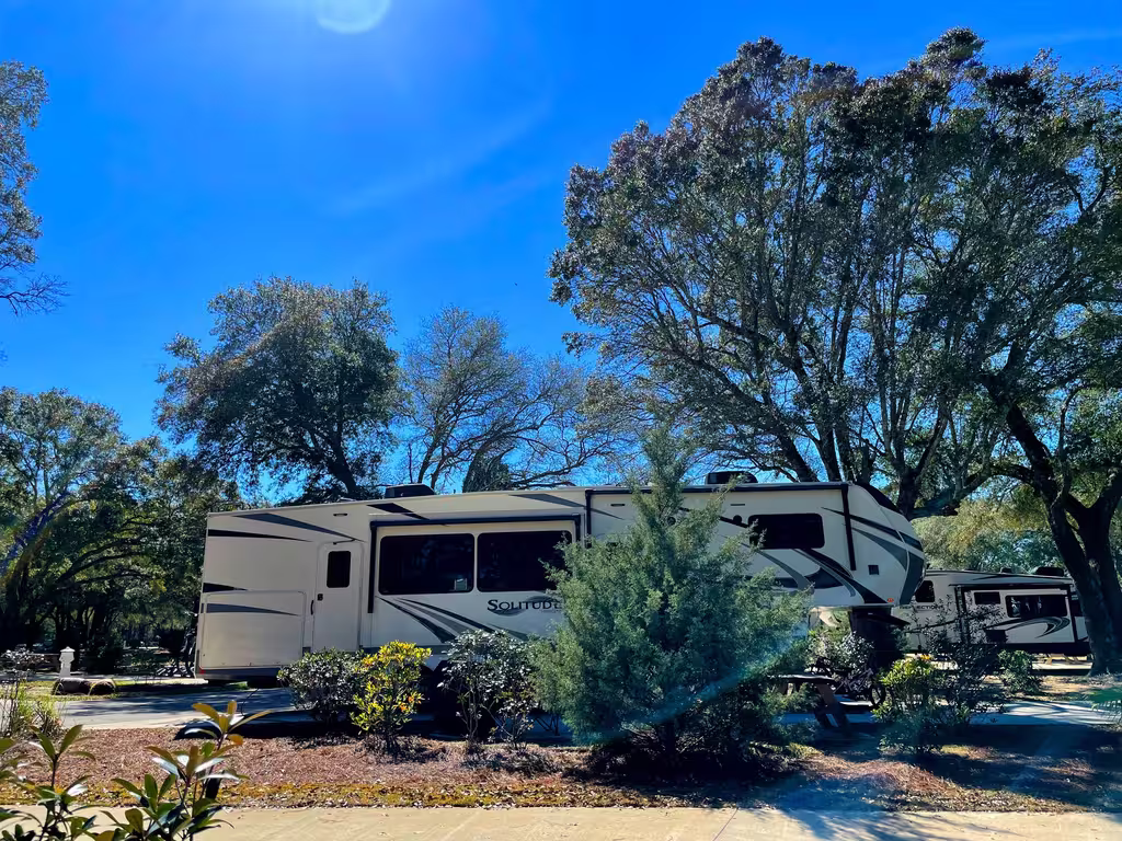 Fifth wheel RV on a shaded full hookup site at Splash RV Resort near Pensacola