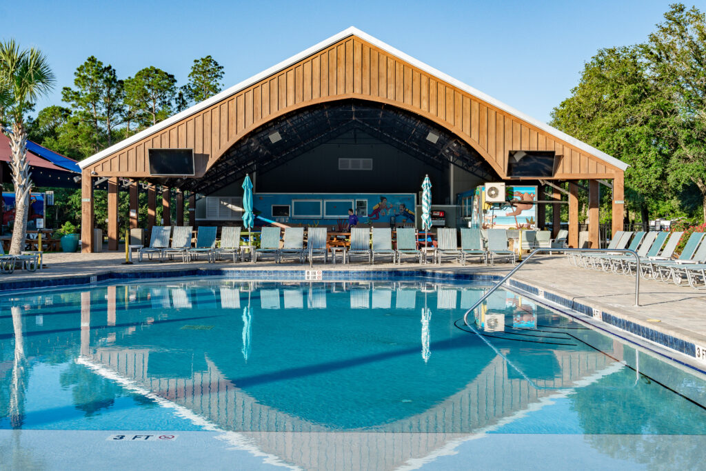 Heated swimming pool and wooden pavilion on a calm day at Splash RV Resort near Navarre Beach