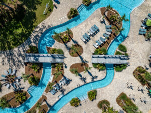 Aerial view of the winding lazy river and pool deck at Splash RV Resort near the Gulf Coast