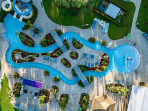 Aerial view of the winding lazy river and pool at Splash RV Resort near Pensacola