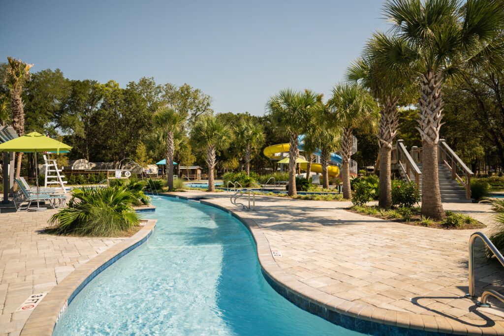 Lazy river, palm trees, and water slides on a sunny day at Splash RV Resort