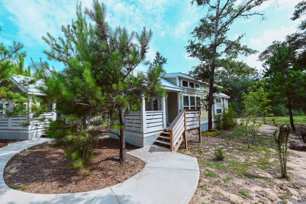 Luxury cottage framed by tall pines at Splash RV Resort near Navarre Beach