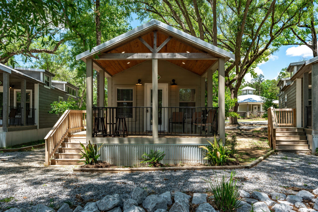 Upscale cottage with a covered porch at Splash RV Resort near Pensacola