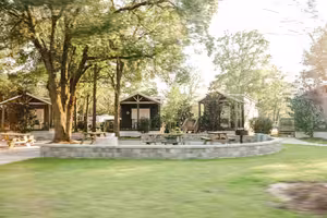 Luxury cottages under shady oak trees at Splash RV Resort near Pensacola