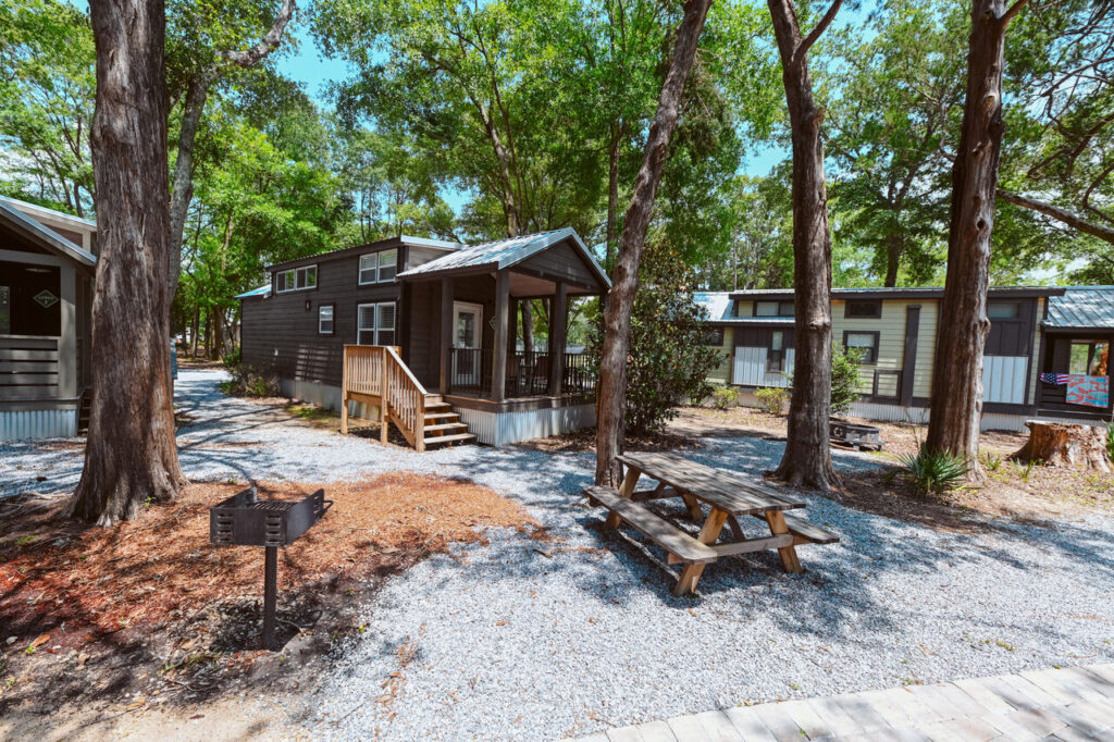 Luxury cottages set among shade trees at Splash RV Resort near Navarre Beach