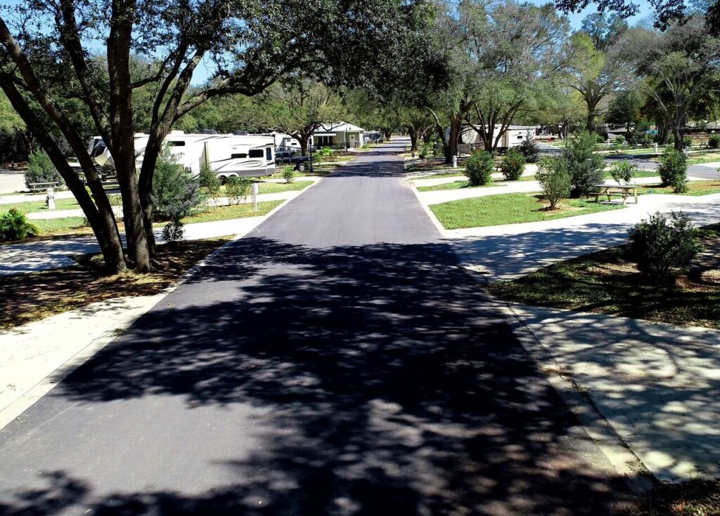 Wide tree-shaded RV road and spacious sites at Splash RV Resort near Pensacola Florida