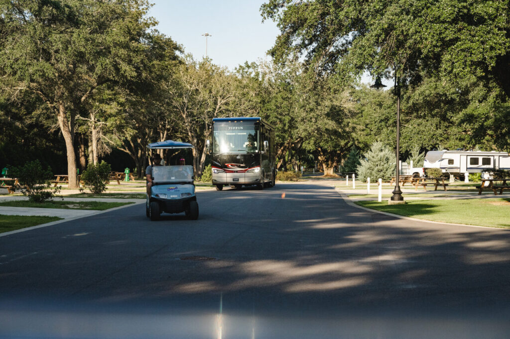 Shaded, spacious RV sites along a tree-lined road at Splash RV Resort near Navarre Beach