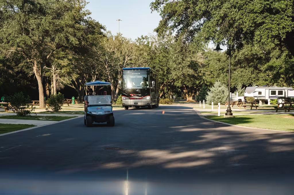 Shaded, spacious RV sites along a tree-lined road at Splash RV Resort near Navarre Beach