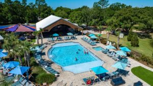 Aerial view of the swimming pool and sun deck at Splash RV Resort near Navarre Beach, Florida