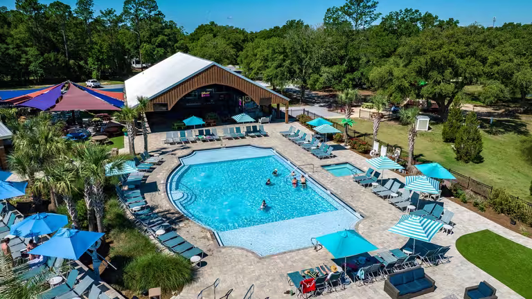 Aerial view of the swimming pool and sun deck at Splash RV Resort near Navarre Beach, Florida