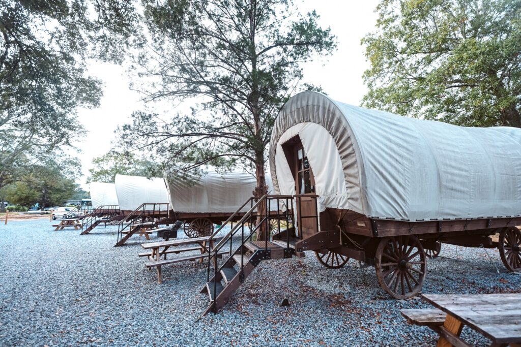A row of Conestoga-style glamping wagons at Splash RV Resort, a family RV resort in Florida near Pensacola