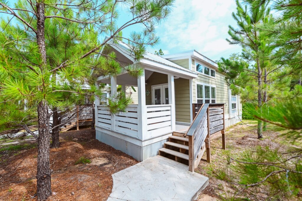 A luxury cottage among tall pines at Splash RV Resort, a family RV resort in Florida near Navarre Beach