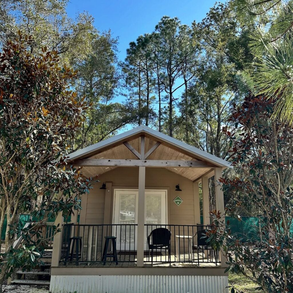 Luxury cottage with a covered porch among the pines near Pensacola at Splash RV Resort