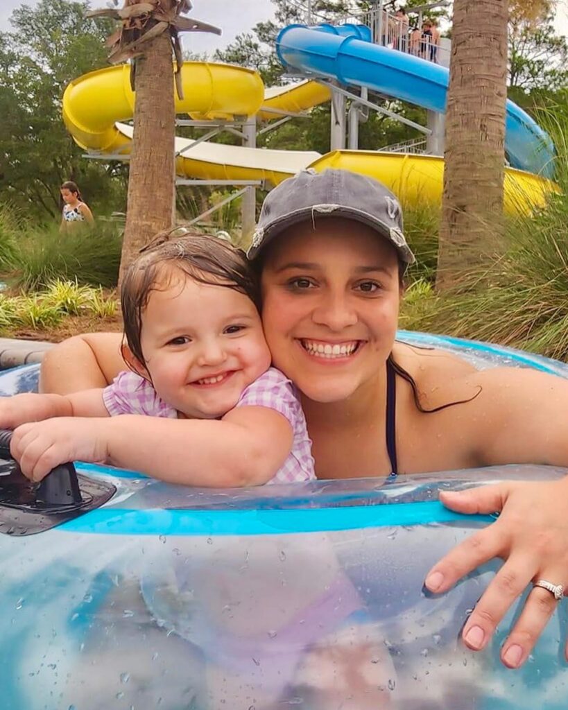 Mother and child float in an inner tube below the water slides at Splash RV Resort near Navarre Beach, Florida