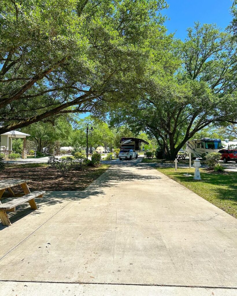 A wide paved full-hookup RV site at Splash RV Resort in Milton FL