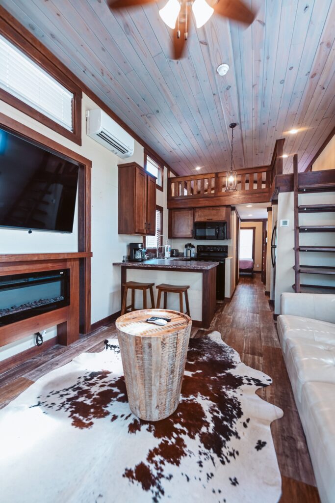 Full kitchen and sleeping loft inside a Splash RV Resort cottage near Fort Walton Beach