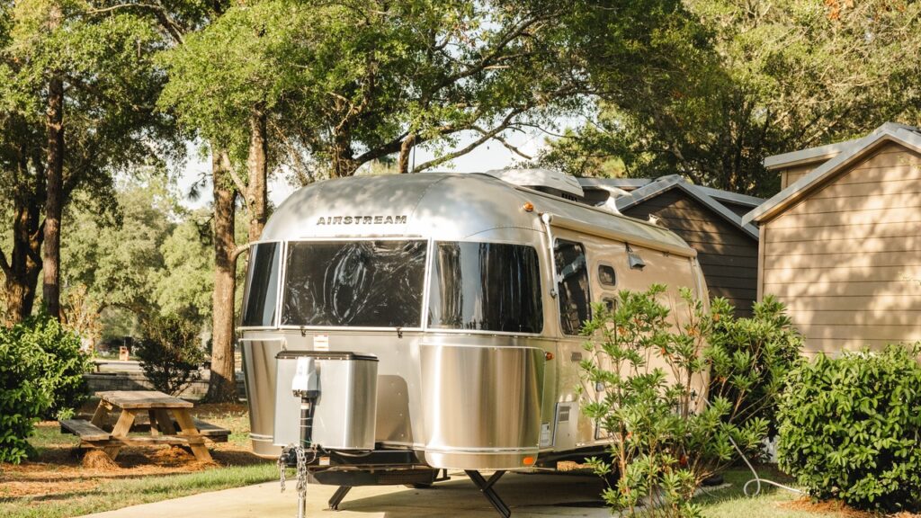 Airstream RV set up on a full-hookup concrete site at a winter RV park near Pensacola and Navarre