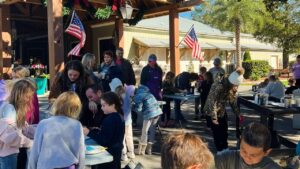 Families making holiday crafts at Splash RV Resort near Pensacola FL during the Christmas season