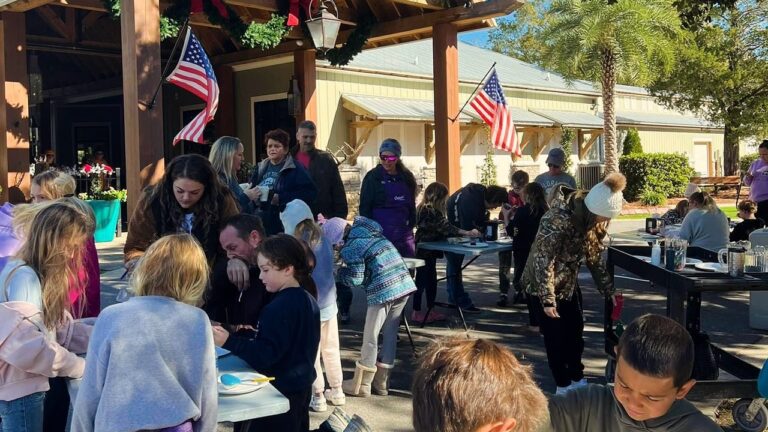 Families making holiday crafts at Splash RV Resort near Pensacola FL during the Christmas season