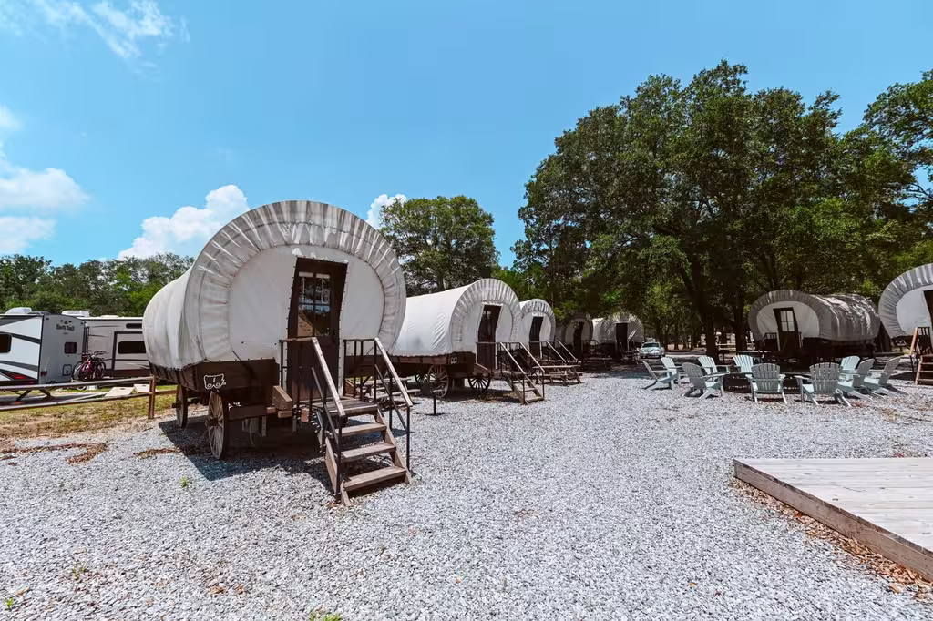 Conestoga-style glamping wagons at Splash RV Resort near Pensacola, Florida.