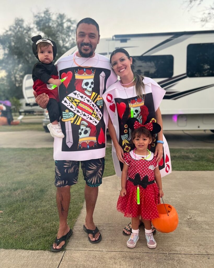 Family in matching Halloween costumes beside their RV at a resort near Pensacola