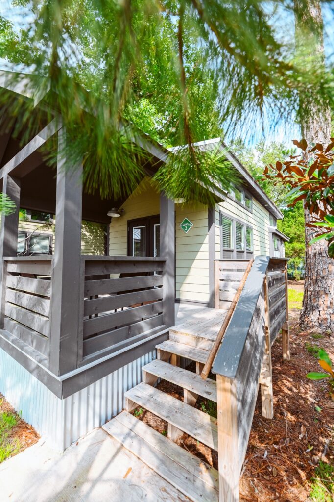 A luxury cottage with a covered porch among the pines at Splash RV Resort in Milton, FL