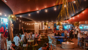 Guests gathered at outdoor tables under string lights at an RV resort near Pensacola, Florida