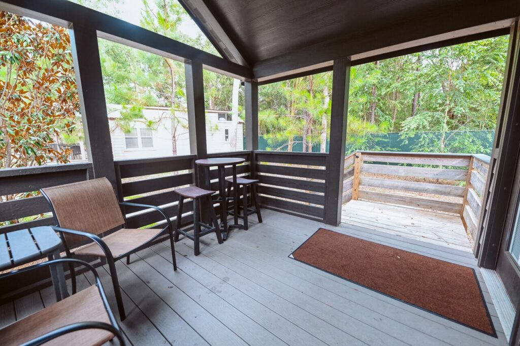 Cottage porch with a high-top table and sling chairs near Perdido Key beach vacation rentals