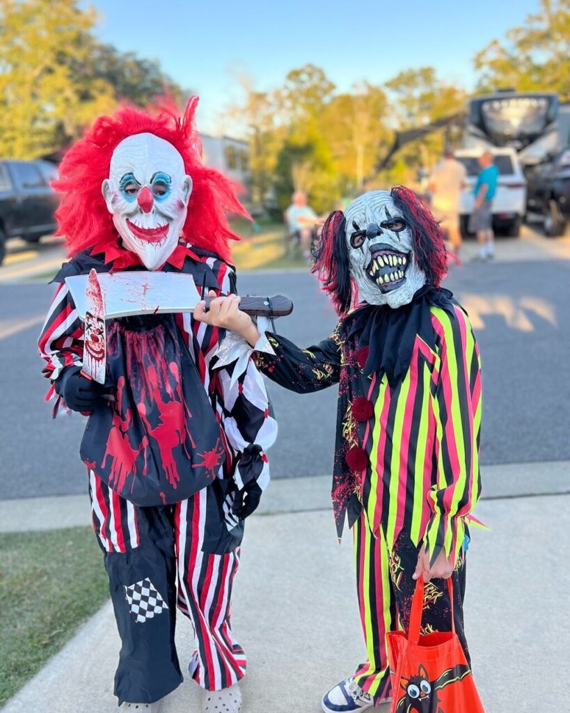 Costumed kids trick-or-treating past RVs during Halloween camping near Pensacola on the Florida Panhandle