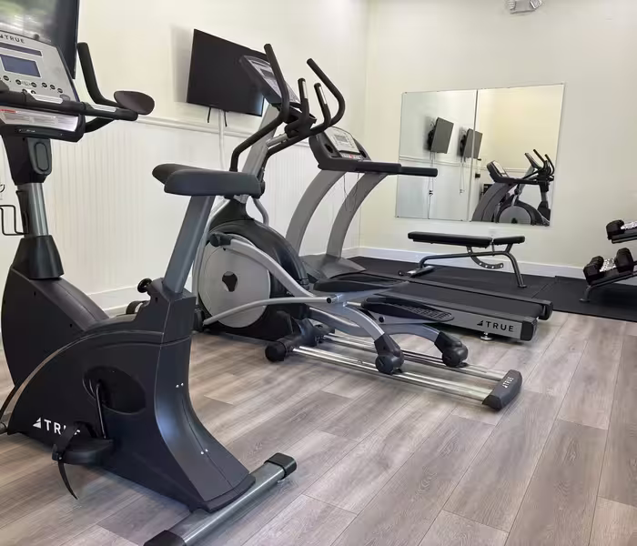 Modern fitness center at Splash RV Resort featuring TRUE cardio equipment like a bike, elliptical, and treadmill.