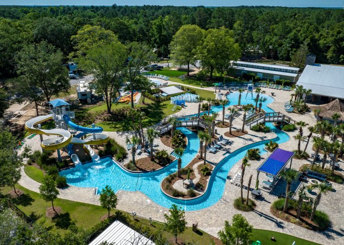 Aerial view of Splash RV Resort water attractions featuring a winding lazy river, swimming pool, and tall yellow and blue