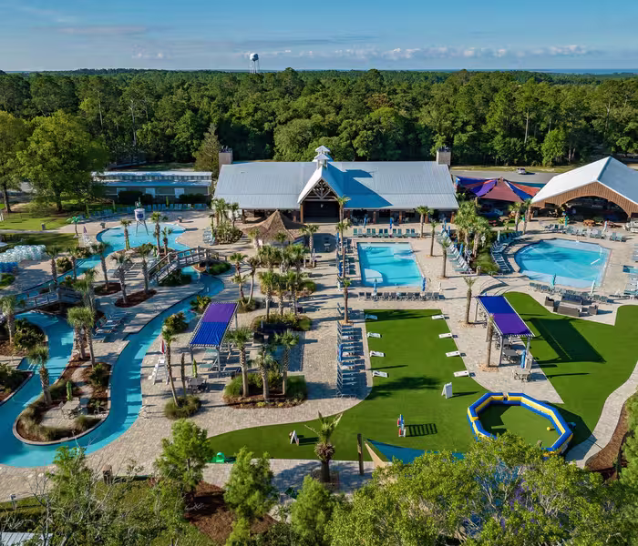 Aerial view of Splash RV Resort's lazy river, swimming pools, and splash pad water playground.