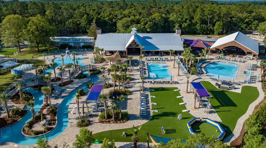 Aerial view of Splash RV Resort's lazy river, swimming pools, and splash pad water playground.