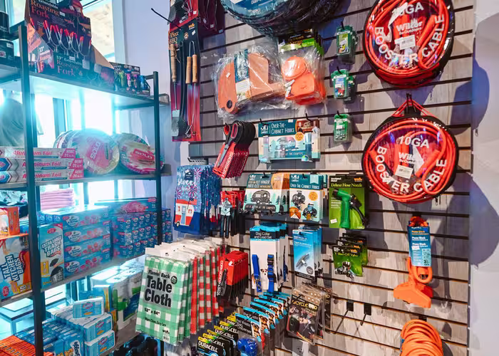 Interior of the Splash RV Resort gift shop displaying camping essentials like storage bins, booster cables, and propane tanks.