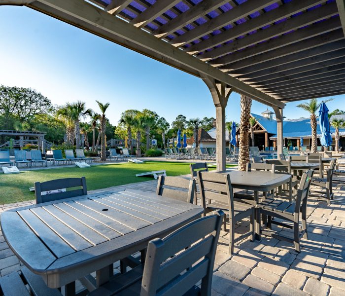 Grand main clubhouse entrance at Splash RV Resort in Milton, Florida with timber-framed portico and colorful bicycles
