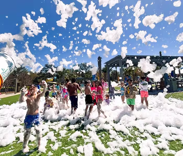 Guests enjoying a foam party at Splash RV Resort's water playground in Milton.