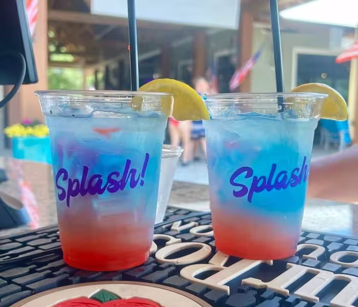 Tropical layered drinks with lemon garnish served at the Splash RV Resort tiki bar.