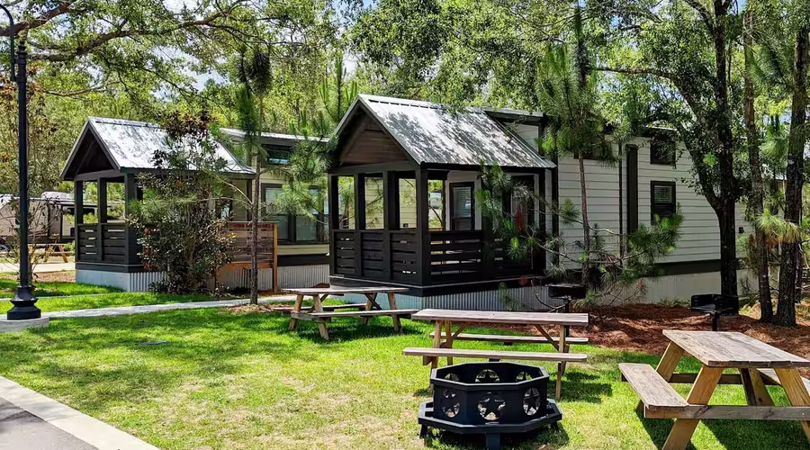 Luxury cottages with screened porches and picnic tables at Splash RV Resort.
